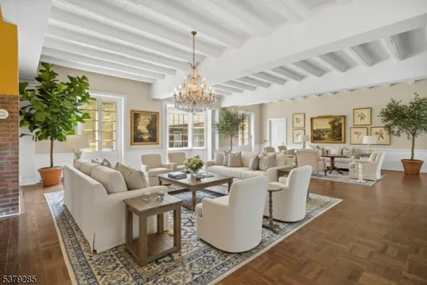 a living room with fireplace furniture and a chandelier