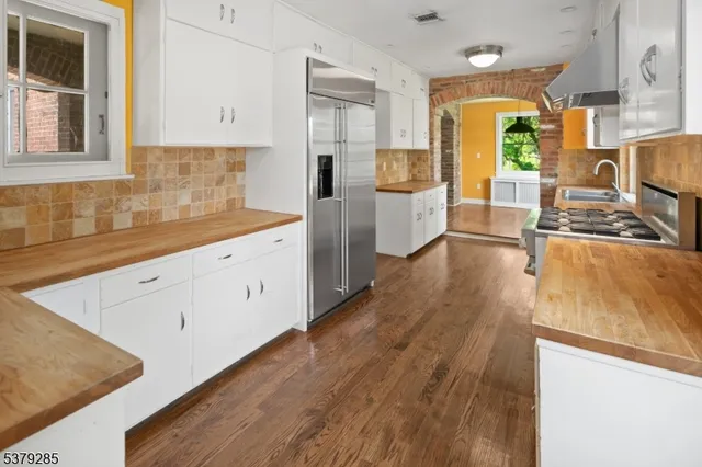 a kitchen with wooden floors and white appliances
