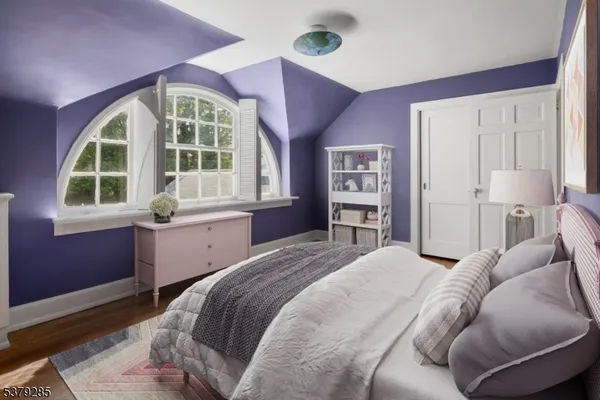 a bedroom with a large bed and a window