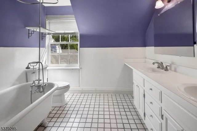 a bathroom with a sink a vanity and a bathtub
