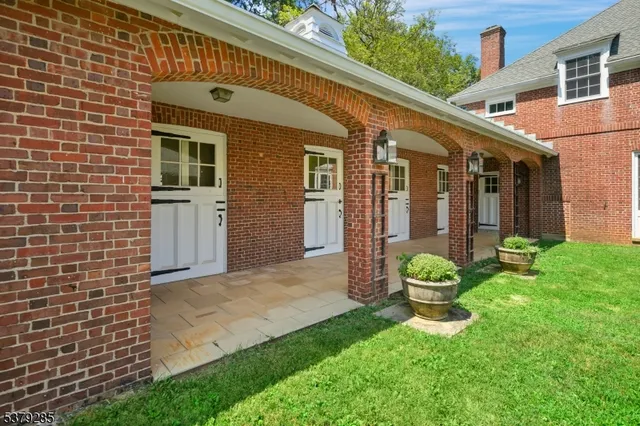 a view of a chair and table in backyard of the house