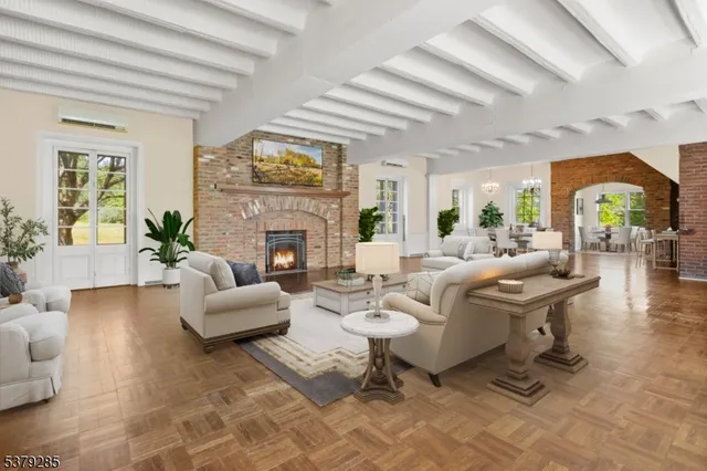 a living room with fireplace furniture and a large window