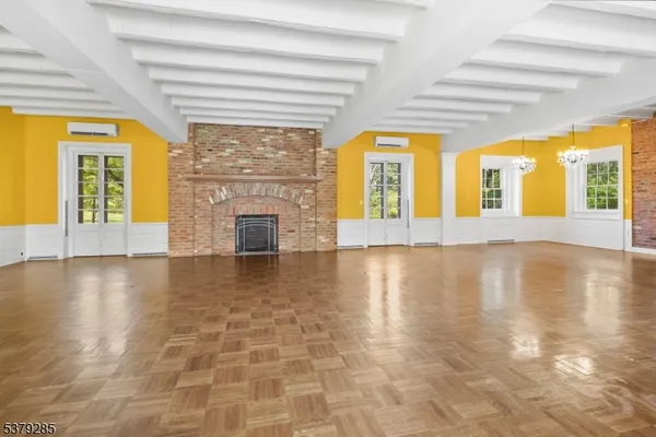 a view of an empty room with a fireplace and a large window