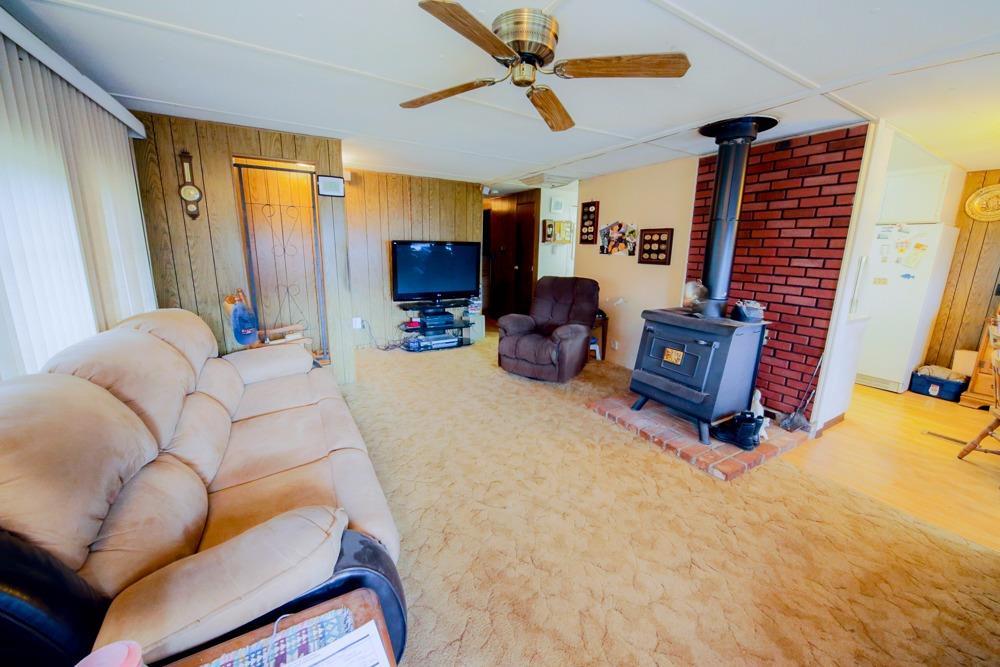 15655 Jones Road White City, OR 97503 - Photo 9 of 28 a living room with furniture a flat screen tv and gym equipment