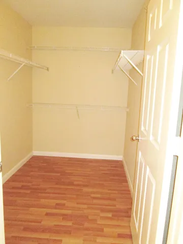 a view of a room with wooden floor and white walls