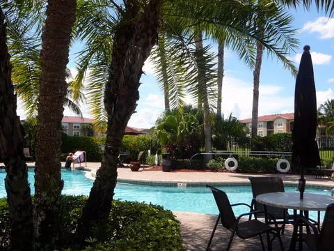 a view of swimming pool outdoor seating and city view