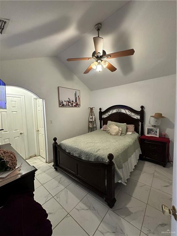 1513 North View Lane Mission, TX 78573 - Photo 14 of 24 a bedroom with a bed and a chandelier