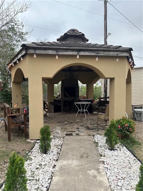 1513 North View Lane Mission, TX 78573 - Photo 22 of 24 a view of house with chair and glass door