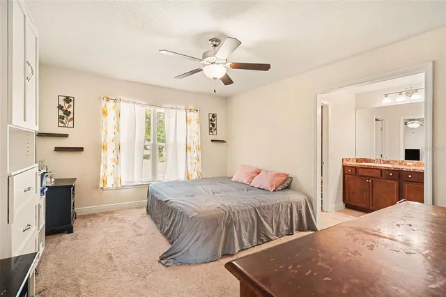 a bedroom with two beds and painting on the wall