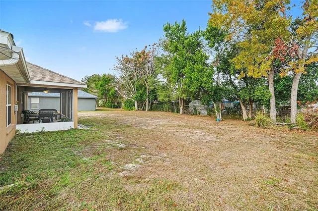 a backyard of a house with table and chairs