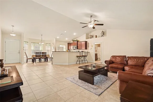 a living room with furniture and kitchen view