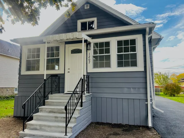 a view of a house with wooden door and a window