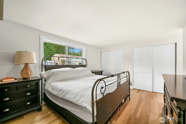 a bedroom with a bed and a mirror