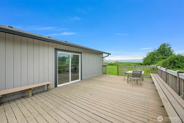 a view of a deck with wooden floor and fence with a garden