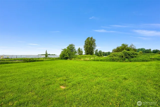 a front view of a house with a garden and trees