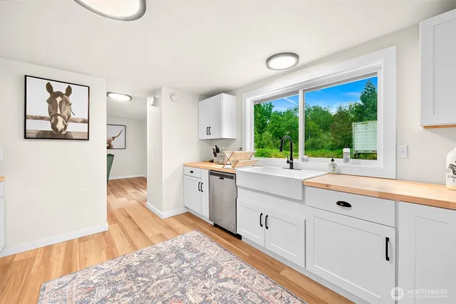 a large white kitchen with a large window