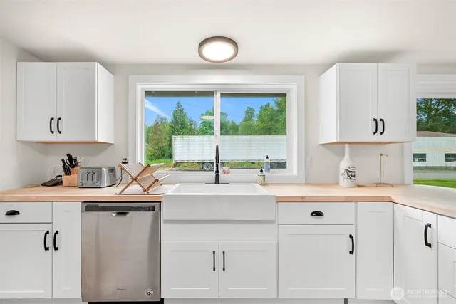a kitchen with sink cabinets and wooden floor