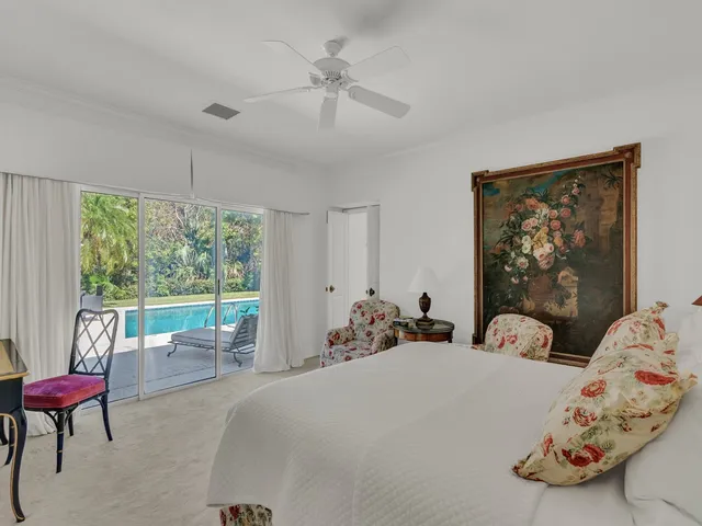 a bed room with two bed and a large window