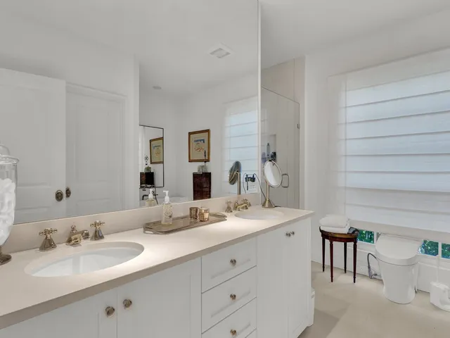 a bathroom with a double vanity sink and a mirror