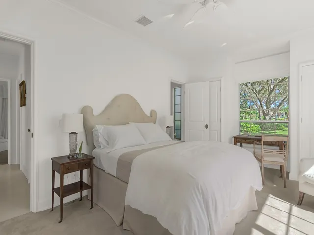 a bedroom with a bed and a table