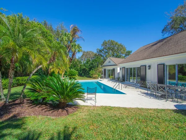 a view of a swimming pool with a yard