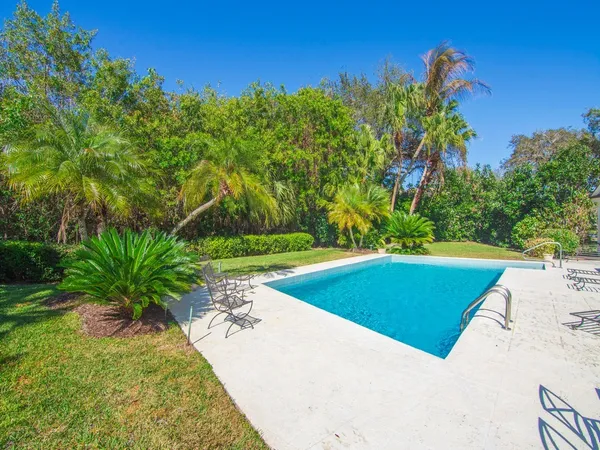 a view of a swimming pool with a yard