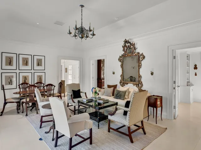 a living room with lots of furniture and chandelier