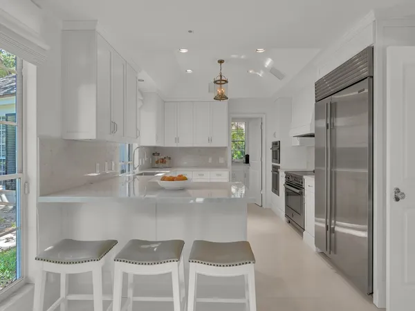 a kitchen with a table chairs and a window