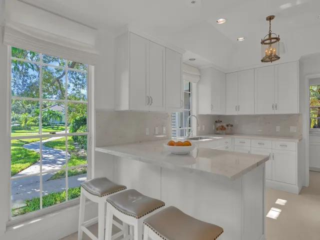 a kitchen with a table chairs and a window