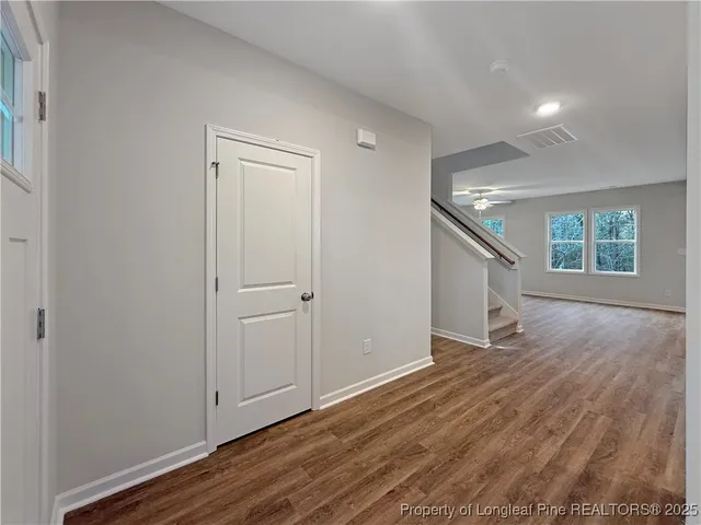 a large kitchen with stainless steel appliances kitchen island granite countertop a large counter top a sink a stove and a wooden floors