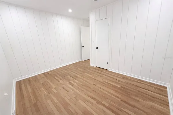 a view of a room with wooden floor and cabinetry