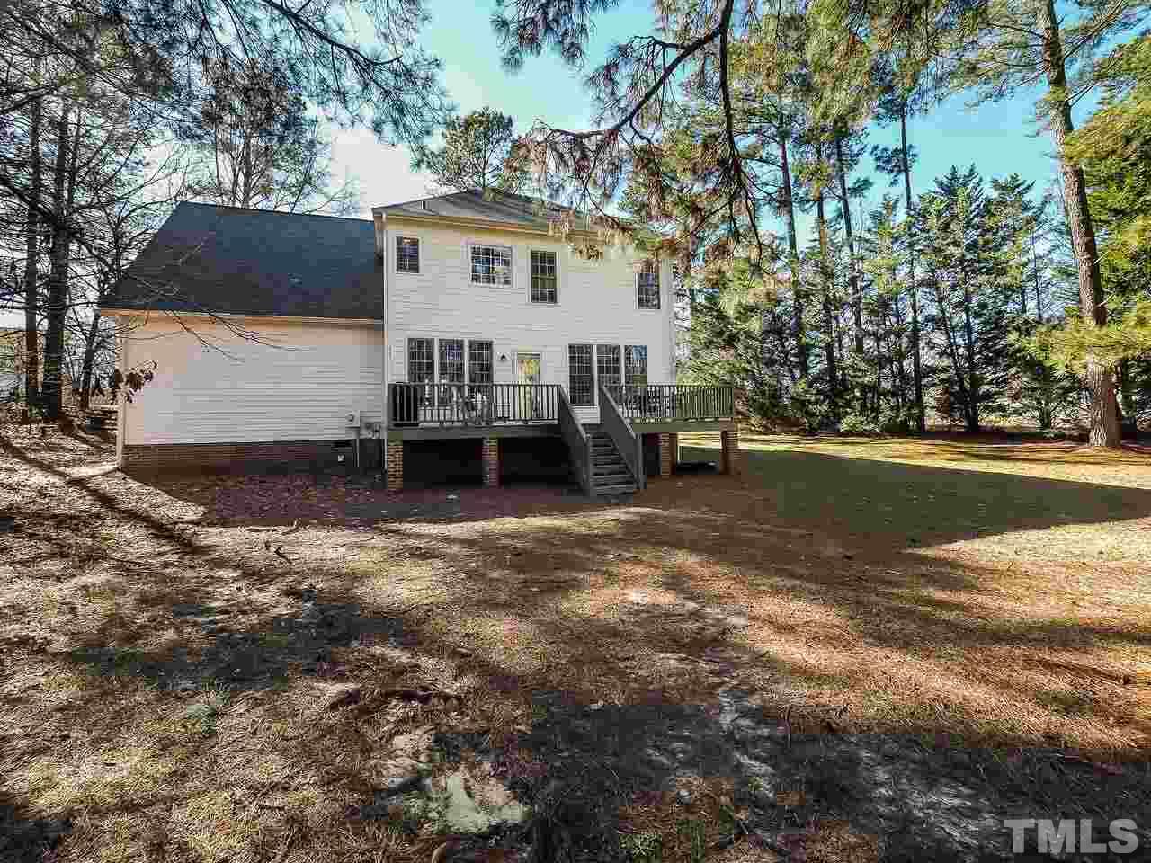 208 Priceview Drive Raleigh, NC 27603 - Photo 22 of 25 a view of a house with backyard and a tree