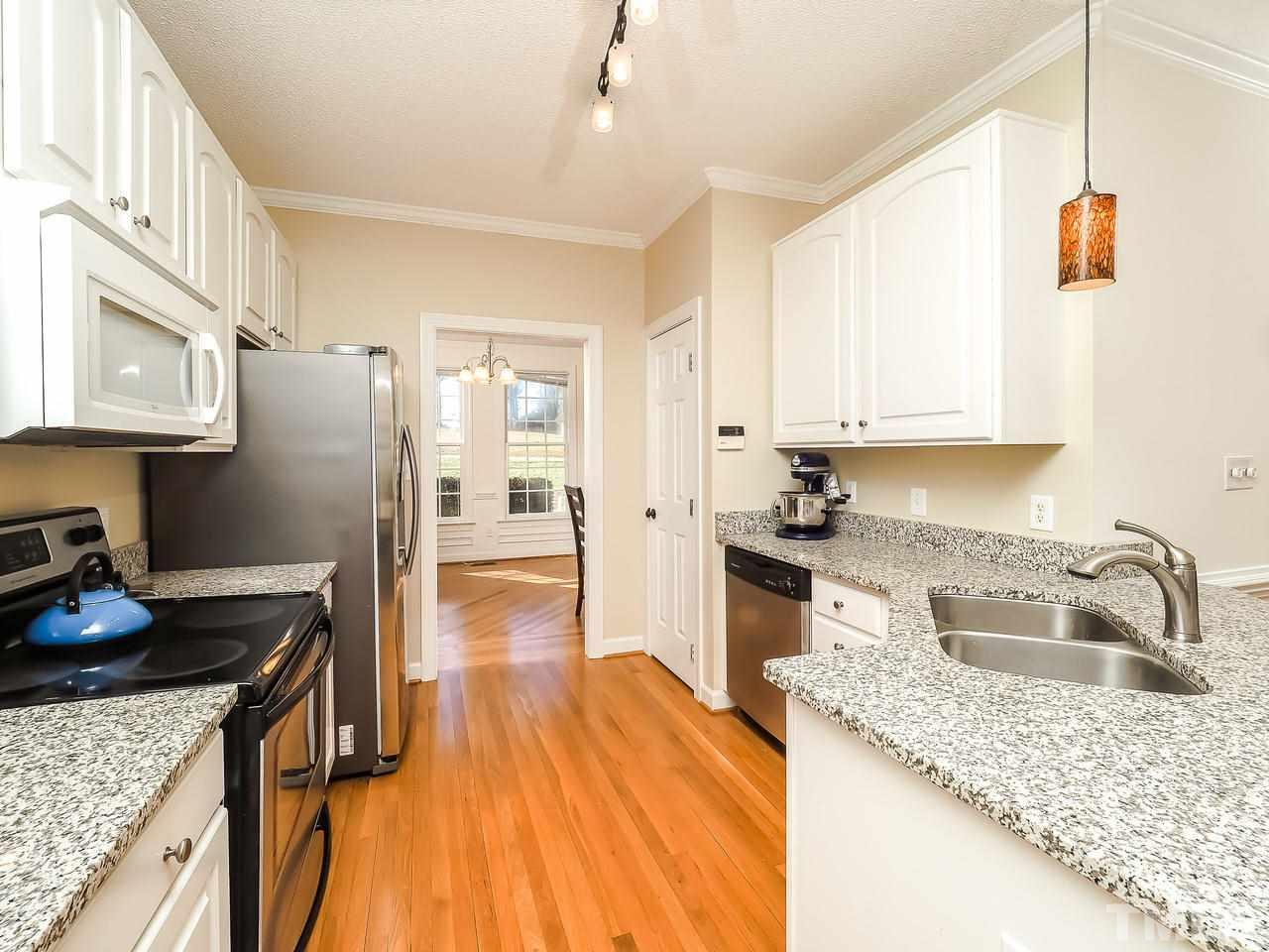 208 Priceview Drive Raleigh, NC 27603 - Photo 8 of 25 a kitchen with a sink stove and refrigerator