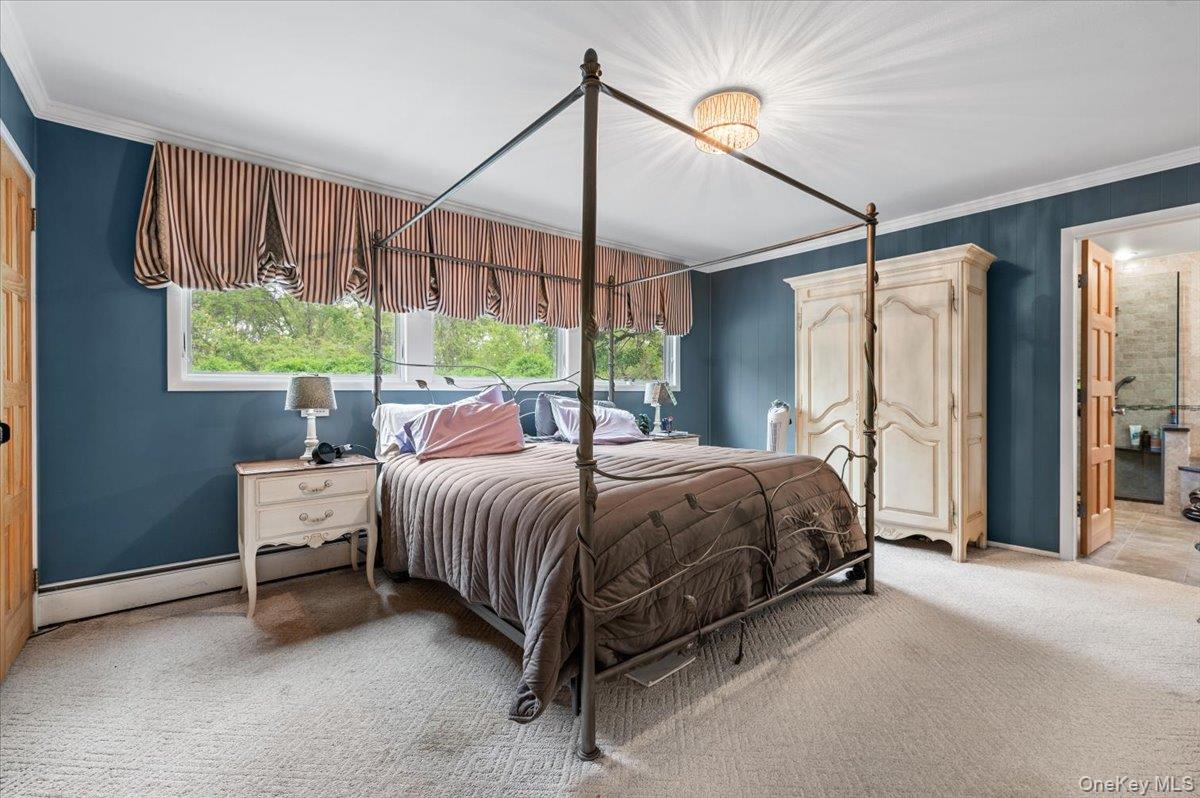 6 Apex Road Melville, NY 11747 - Photo 23 of 50 a spacious bedroom with a bed and large window