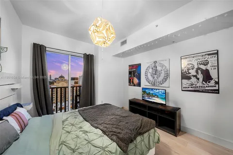 a bedroom with furniture and a chandelier