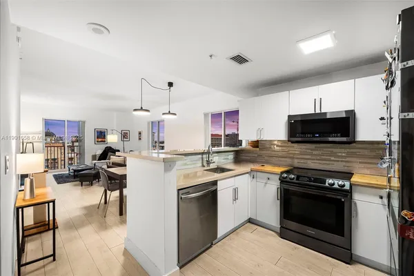 a kitchen with a sink stove and microwave