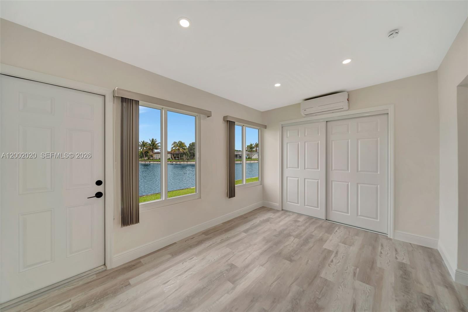 8502 Northwest 59th Street Tamarac, FL 33321 - Photo 12 of 18 a view of an empty room with wooden floor and a window