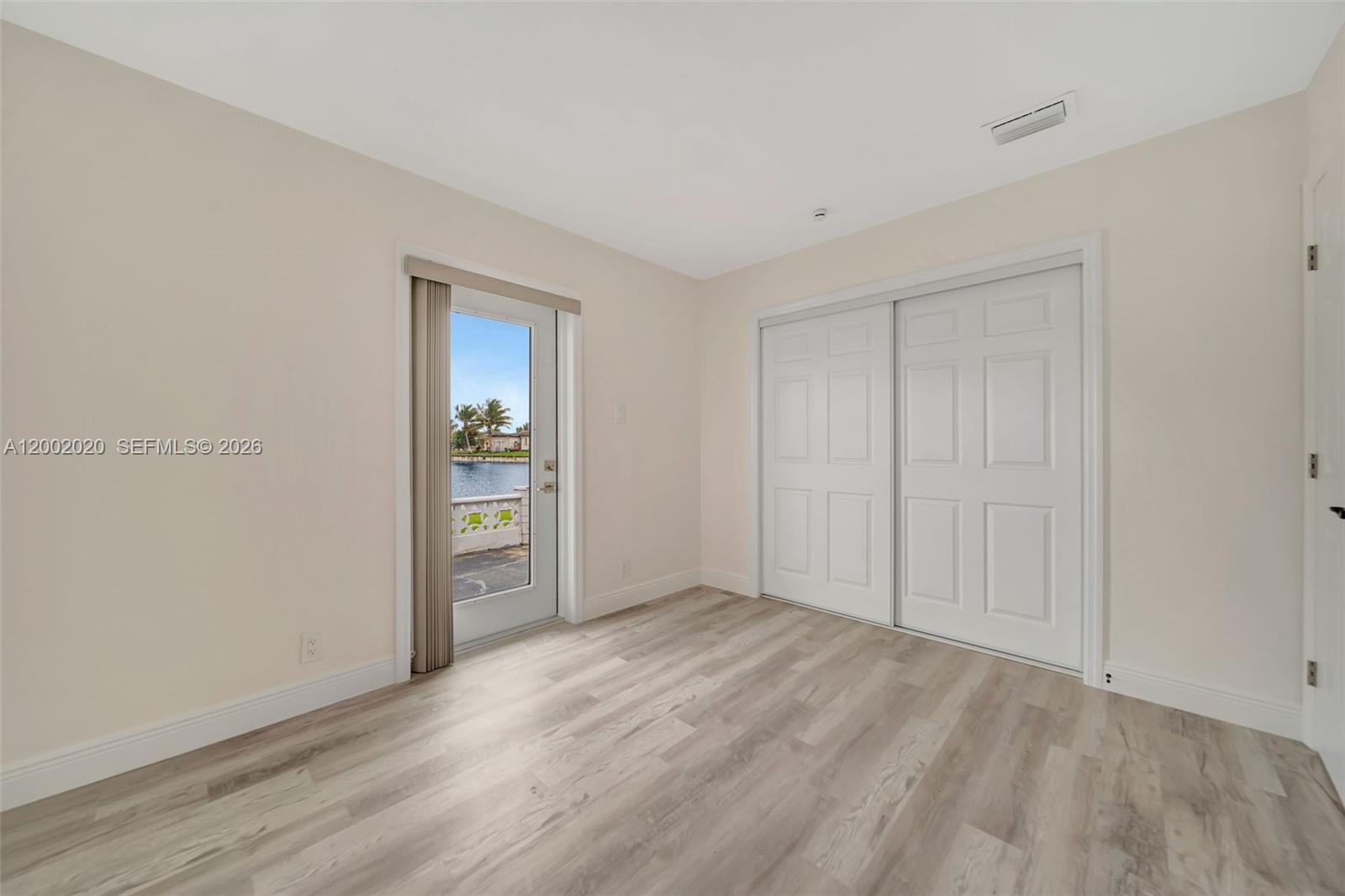 8502 Northwest 59th Street Tamarac, FL 33321 - Photo 18 of 18 a view of an empty room with wooden floor and a window