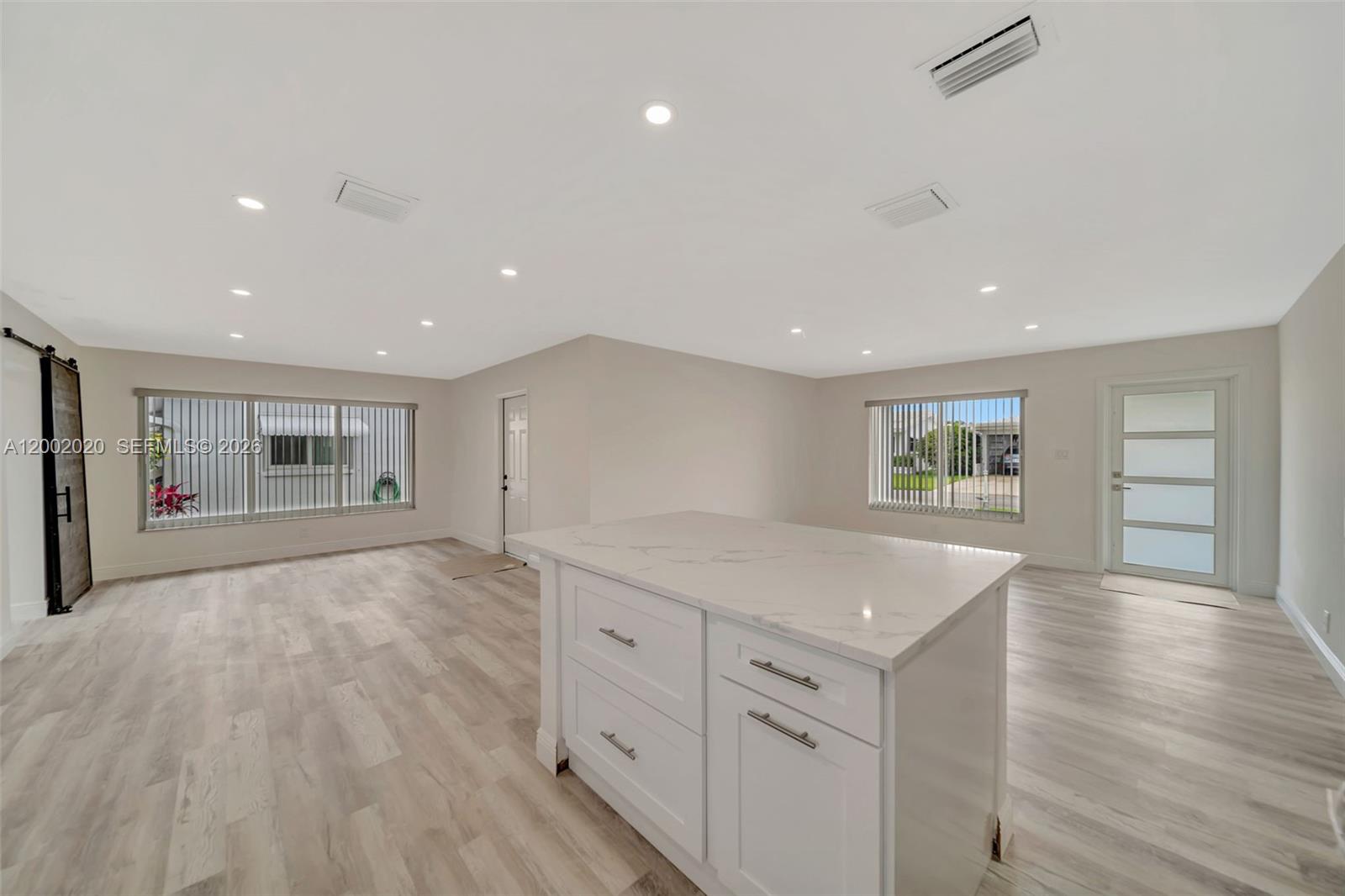 8502 Northwest 59th Street Tamarac, FL 33321 - Photo 6 of 18 a view of kitchen with center island and hallway