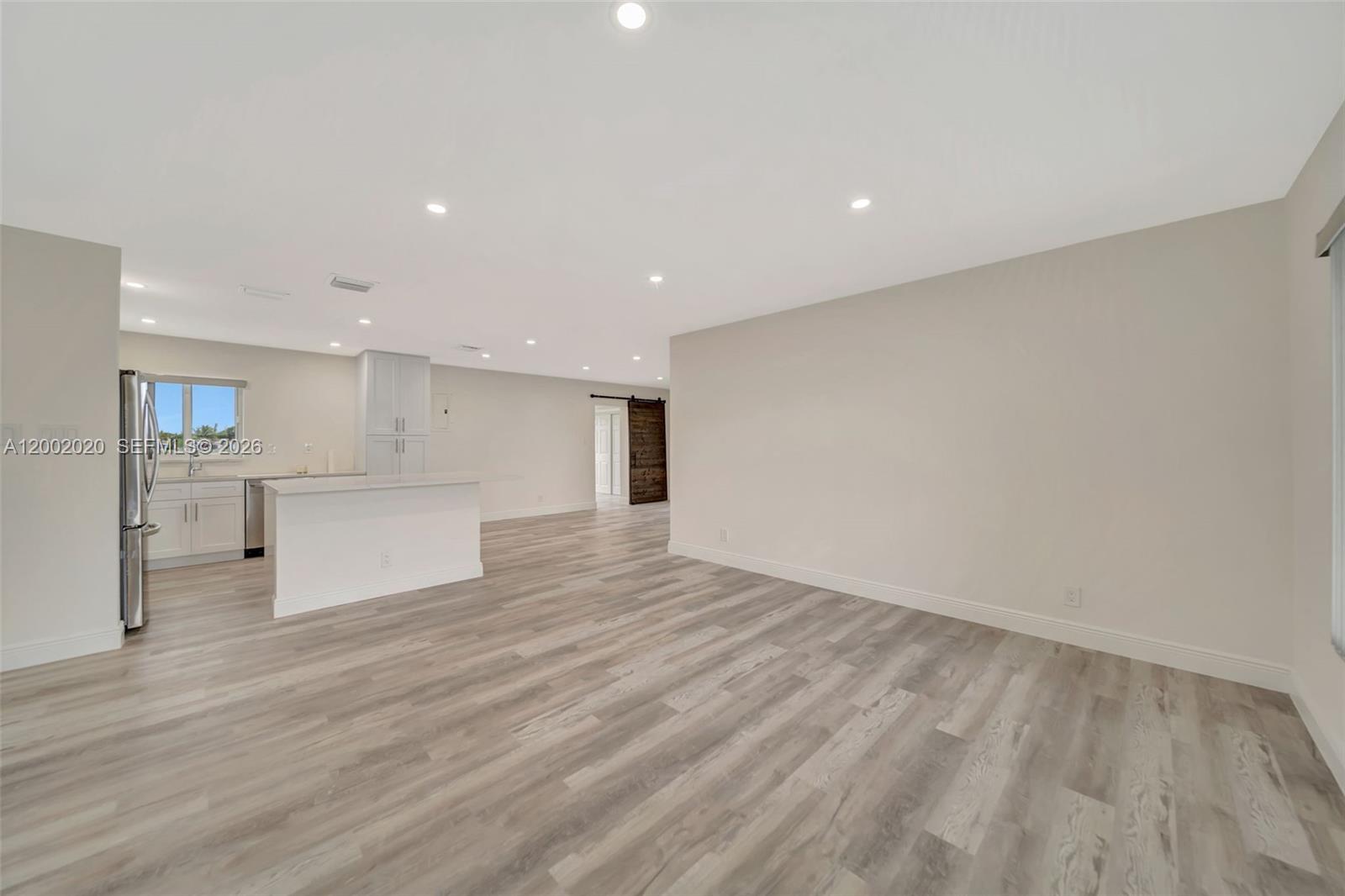 8502 Northwest 59th Street Tamarac, FL 33321 - Photo 7 of 18 a view of kitchen entryway with wooden floor