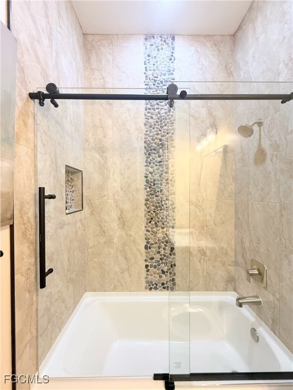 338 Partridge Street Lehigh Acres, FL 33974 - Photo 14 of 30 a bathroom with a shower and a bath tub