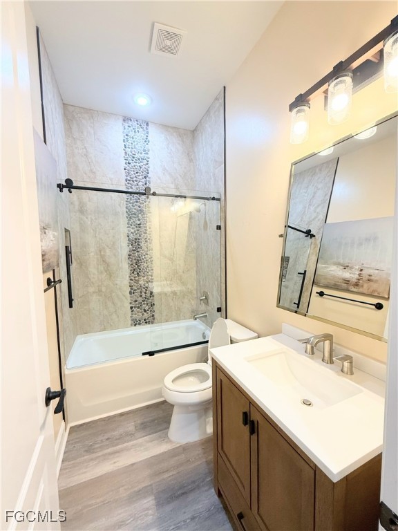 338 Partridge Street Lehigh Acres, FL 33974 - Photo 16 of 30 a bathroom with a sink mirror toilet and bathtub