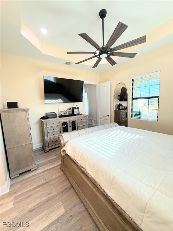 338 Partridge Street Lehigh Acres, FL 33974 - Photo 23 of 30 a bedroom with a bed and a flat screen tv