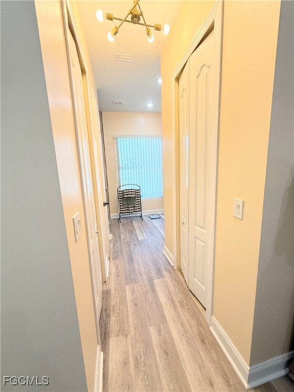 338 Partridge Street Lehigh Acres, FL 33974 - Photo 25 of 30 a view of a hallway with wooden floor and staircase
