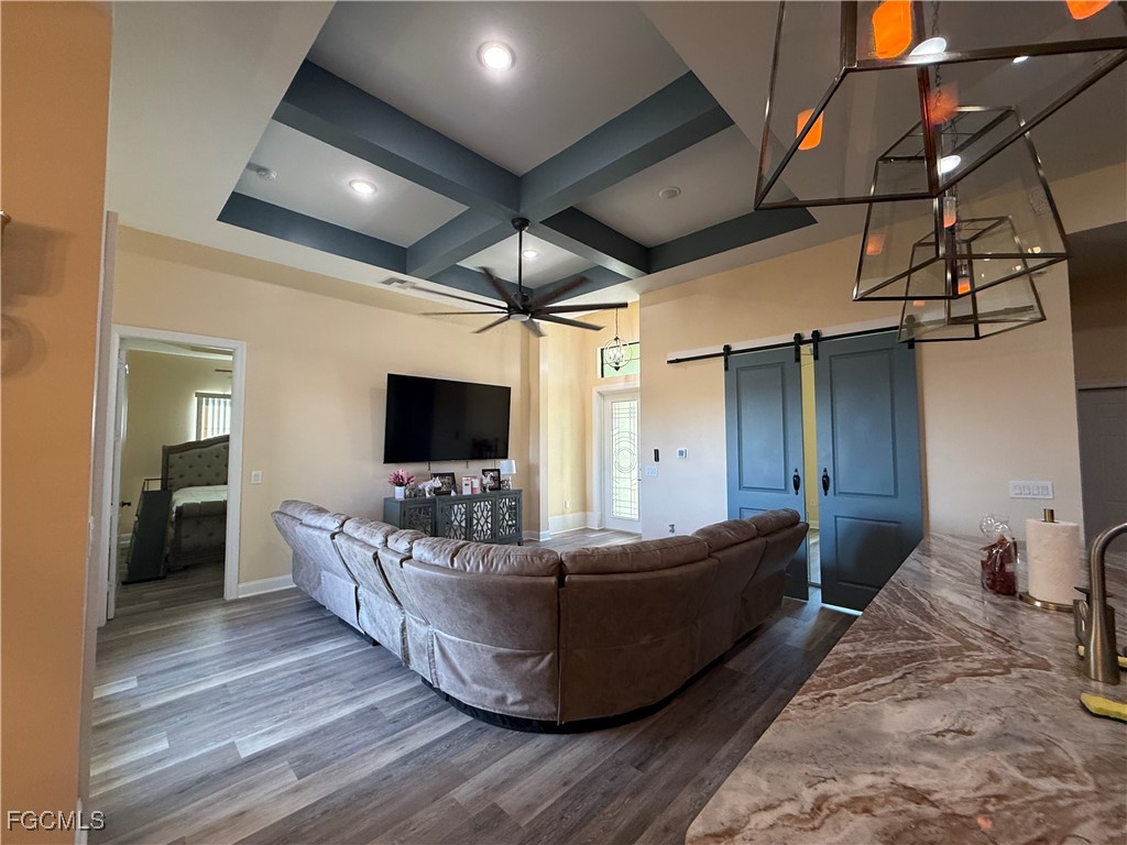 338 Partridge Street Lehigh Acres, FL 33974 - Photo 6 of 30 a living room with furniture and a flat screen tv