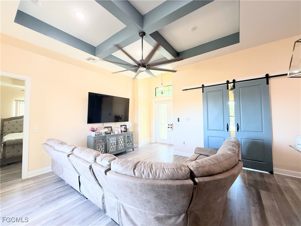 338 Partridge Street Lehigh Acres, FL 33974 - Photo 10 of 30 a living room with furniture and a flat screen tv