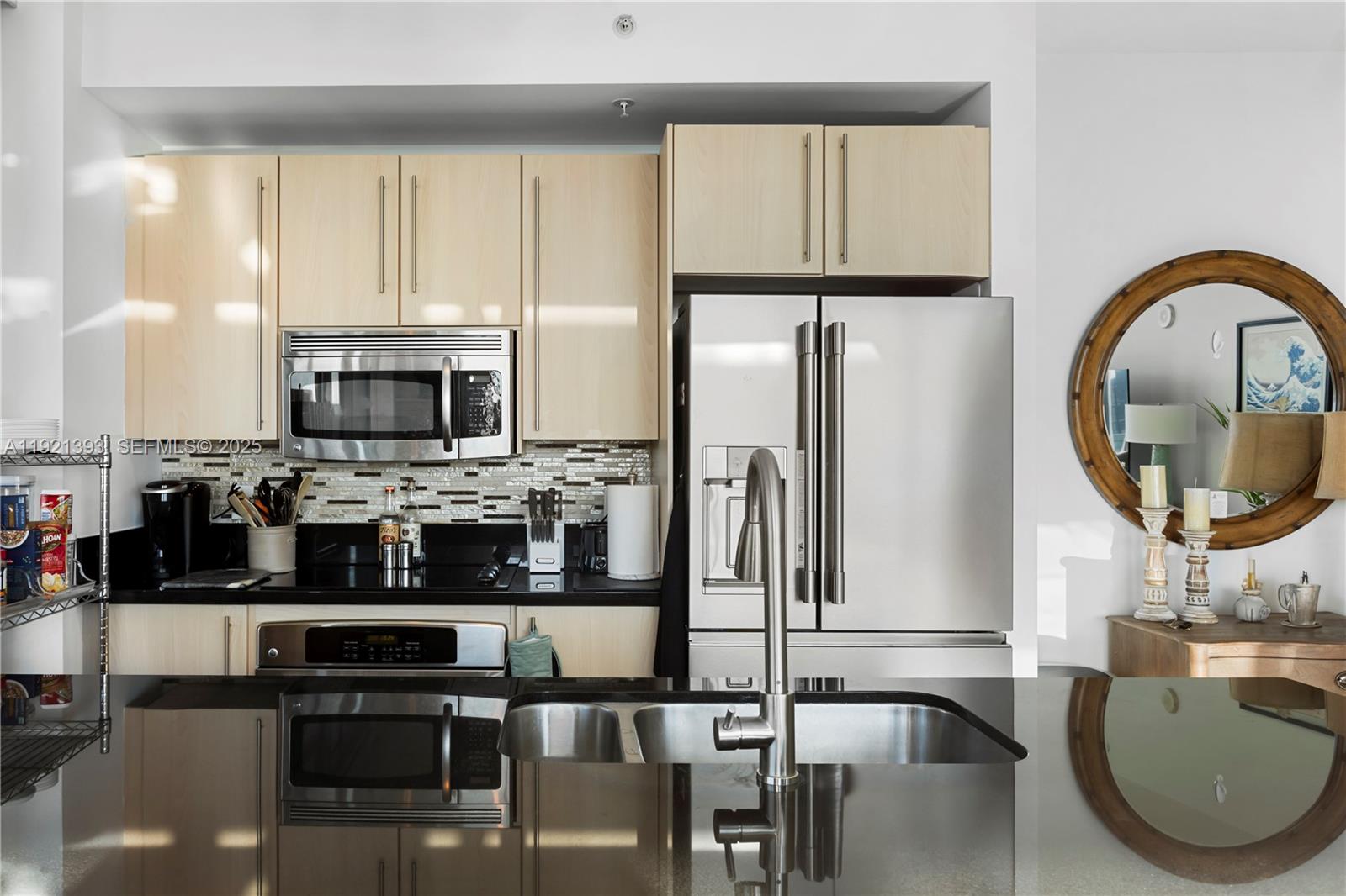 1111 Southwest 1st Avenue, Unit 2925N Miami, FL 33130 - Photo 3 of 19 a kitchen with stainless steel appliances granite countertop a stove a refrigerator a microwave a sink and cabinets