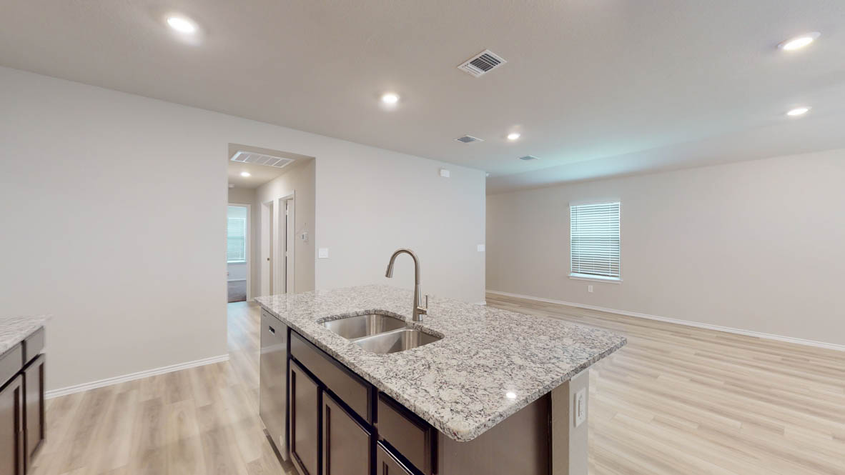 561 Hector Loop Georgetown, TX 78626 - Photo 6 of 30 a kitchen with granite countertop a sink and cabinets