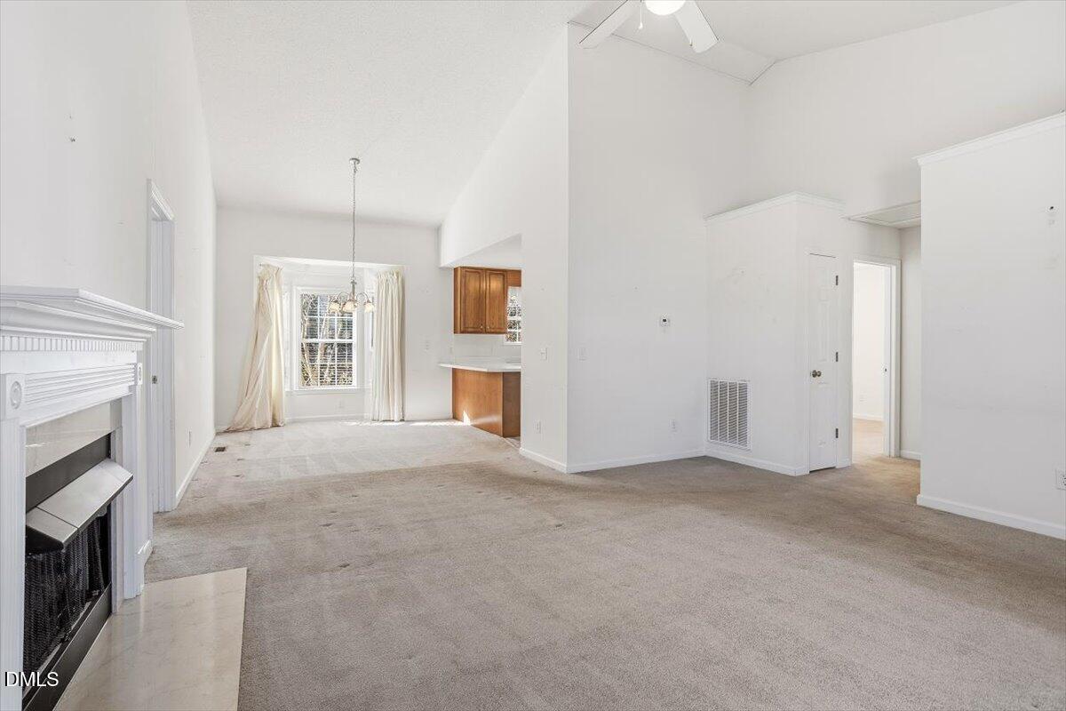 130 Muirfield Ridge Drive Garner, NC 27529 - Photo 2 of 29 an empty room with windows and fireplace