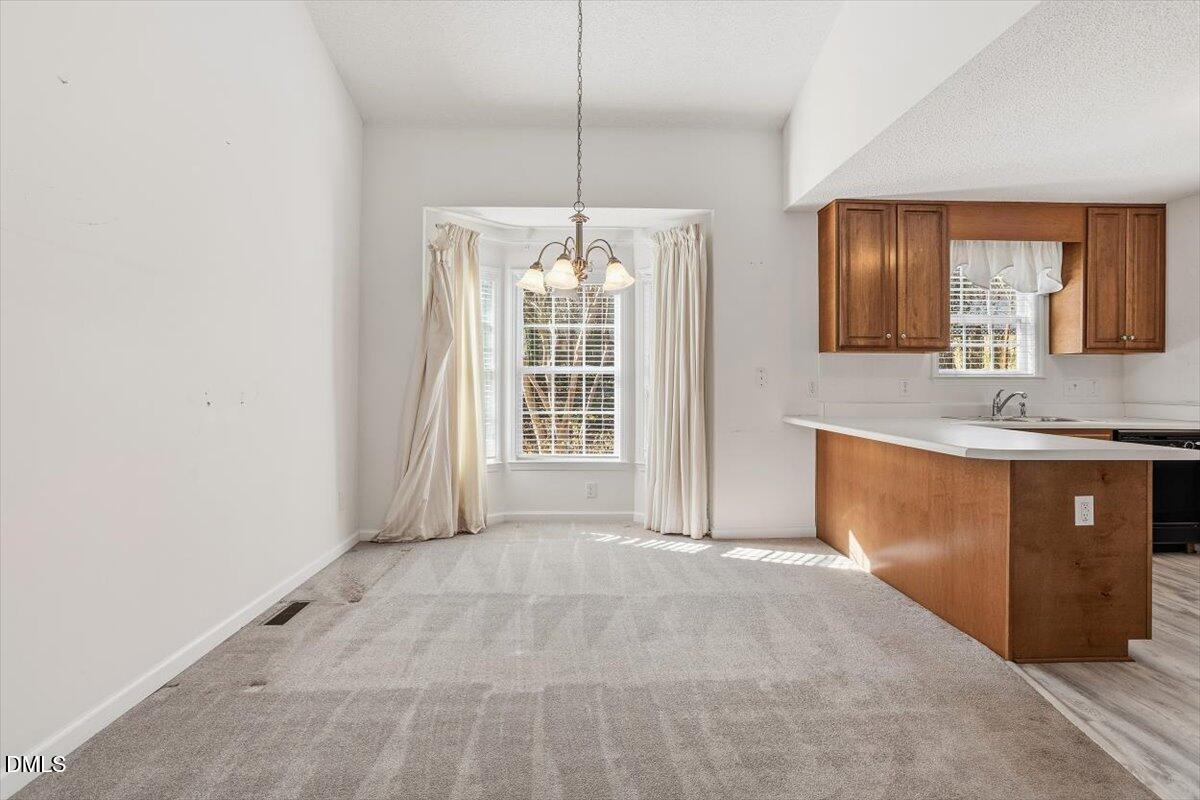 130 Muirfield Ridge Drive Garner, NC 27529 - Photo 6 of 29 a spacious bathroom with a granite countertop sink and a mirror